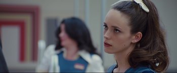 Movie still from “High-Rise” (2015), directed by Ben Wheatley – A woman standing next to another woman in front of a building; Close Up shot, Over the shoulder angle