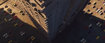 Movie still from “High-Rise” (2015), directed by Ben Wheatley – An aerial view of a tall building in the dark; Extreme Wide shot, Overhead angle