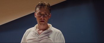 Movie still from “High-Rise” (2015), directed by Ben Wheatley – A person with wet hair; Medium shot, Low angle
