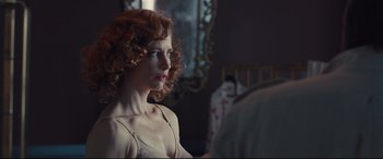 Movie still from “High-Rise” (2015), directed by Ben Wheatley – A woman with red curly hair sitting in front of a mirror; Close Up shot, Over the shoulder angle