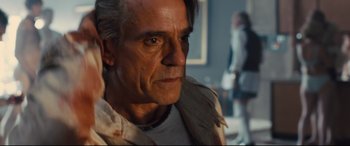 Movie still from “High-Rise” (2015), directed by Ben Wheatley – A person wearing a jacket; Close Up shot, Over the shoulder angle