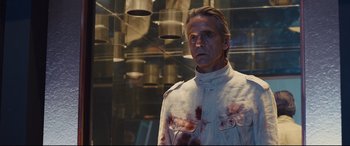 Movie still from “High-Rise” (2015), directed by Ben Wheatley – A man in a white jacket with blood on his face; Close Up shot, Low angle