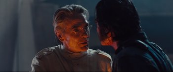 Movie still from “High-Rise” (2015), directed by Ben Wheatley – A man and a woman face to face in a dark room; Close Up shot, Over the shoulder angle