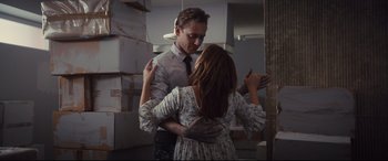 Movie still from “High-Rise” (2015), directed by Ben Wheatley – A man and a woman are dancing in a room; Medium shot, Low angle