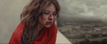 Movie still from “High-Rise” (2015), directed by Ben Wheatley – A person with blood on her face; Close Up shot, Low angle