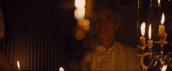 Movie still from “High-Rise” (2015), directed by Ben Wheatley – A man in a white shirt is looking at the camera; Close Up shot, Low angle