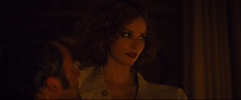 Movie still from “High-Rise” (2015), directed by Ben Wheatley – A person with curly brown hair; Close Up shot, Over the shoulder angle