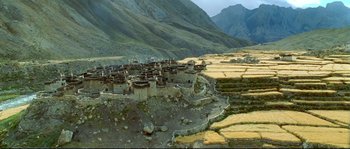 Movie still from “Himalaya” (1999), directed by Eric Valli – An aerial view of a village in a mountainous area; Extreme Wide shot, High angle