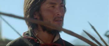 Movie still from “Himalaya” (1999), directed by Eric Valli – A person holding a stick in his hand; Close Up shot, Over the shoulder angle