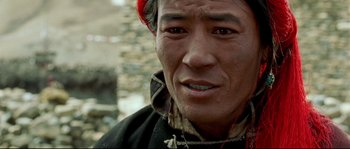 Movie still from “Himalaya” (1999), directed by Eric Valli – A person wearing a jacket; Close Up shot, High angle