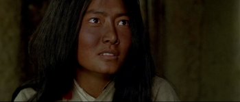 Movie still from “Himalaya” (1999), directed by Eric Valli – A woman with long black hair looking to her left; Close Up shot, High angle