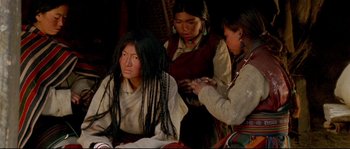 Movie still from “Himalaya” (1999), directed by Eric Valli – A group of women standing next to each other in a room; Medium shot, High angle
