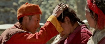Movie still from “Himalaya” (1999), directed by Eric Valli – A man and a woman are combing each others hair; Close Up shot, Over the shoulder angle