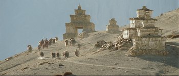 Movie still from “Himalaya” (1999), directed by Eric Valli – A group of animals walking down a hill; Extreme Wide shot, High angle