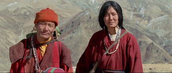 Movie still from “Himalaya” (1999), directed by Eric Valli – Two women in traditional clothing standing next to each other on a hill; Medium shot, High angle