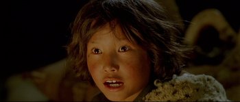 Movie still from “Himalaya” (1999), directed by Eric Valli – A young girl's face; Close Up shot, High angle