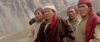 Movie still from “Himalaya” (1999), directed by Eric Valli – A group of people standing next to each other on top of a hill; Close Up shot, High angle