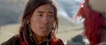 Movie still from “Himalaya” (1999), directed by Eric Valli – A person with long black hair; Close Up shot, High angle