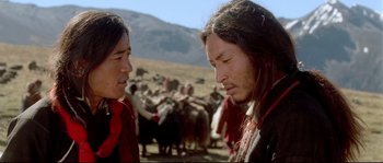 Movie still from “Himalaya” (1999), directed by Eric Valli – Two men are standing in front of a herd of animals; Close Up shot, Over the shoulder angle
