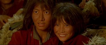 Movie still from “Himalaya” (1999), directed by Eric Valli – A couple of people that are posing for a picture; Close Up shot, High angle
