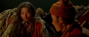 Movie still from “Himalaya” (1999), directed by Eric Valli – Two people are sitting in a dark room; Close Up shot, Over the shoulder angle