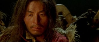 Movie still from “Himalaya” (1999), directed by Eric Valli – A person with long brown hair; Close Up shot, High angle