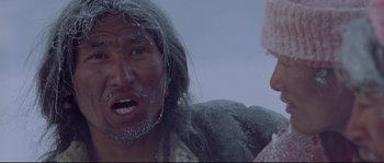 Movie still from “Himalaya” (1999), directed by Eric Valli – An old man with a beard and a long mustache; Close Up shot, Low angle