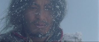 Movie still from “Himalaya” (1999), directed by Eric Valli – A person with snow on his face; Close Up shot, Low angle