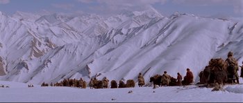 Movie still from “Himalaya” (1999), directed by Eric Valli – A group of men riding on the backs of horses in the snow; Extreme Wide shot, High angle