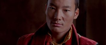 Movie still from “Himalaya” (1999), directed by Eric Valli – A person wearing a red shirt; Close Up shot, High angle