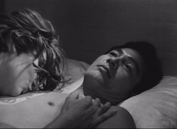Movie still from “Hiroshima Mon Amour” (1959), directed by Alain Resnais – A man and a woman laying in a bed together; Close Up shot, High angle