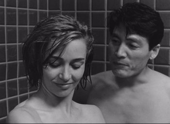 Movie still from “Hiroshima Mon Amour” (1959), directed by Alain Resnais – A man and a woman in the shower together; Close Up shot, Over the shoulder angle