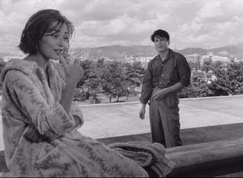 Movie still from “Hiroshima Mon Amour” (1959), directed by Alain Resnais – A man and a woman standing on top of a hill; Medium shot, Over the shoulder angle