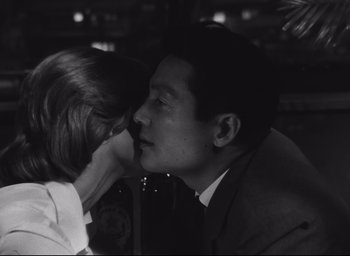 Movie still from “Hiroshima Mon Amour” (1959), directed by Alain Resnais – A man and a little girl kissing each other; Close Up shot, Over the shoulder angle