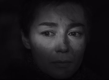 Movie still from “Hiroshima Mon Amour” (1959), directed by Alain Resnais – A black and white photo of a woman's face; Close Up shot, High angle