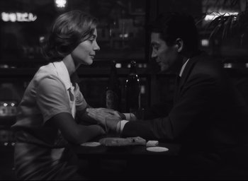 Movie still from “Hiroshima Mon Amour” (1959), directed by Alain Resnais – A man and a woman sitting at a table; Medium shot, Over the shoulder angle