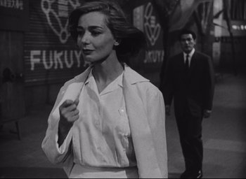Movie still from “Hiroshima Mon Amour” (1959), directed by Alain Resnais – A black - and - white photo of a woman and a man; Medium shot, Low angle