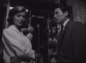 Movie still from “Hiroshima Mon Amour” (1959), directed by Alain Resnais – A man and a woman standing next to each other; Medium shot, Low angle