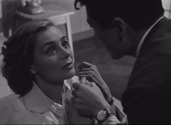 Movie still from “Hiroshima Mon Amour” (1959), directed by Alain Resnais – A man putting a tie on a woman's neck; Close Up shot, Over the shoulder angle