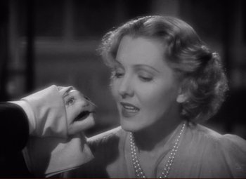 Movie still from “History Is Made at Night” (1937), directed by Frank Borzage – An old photo of a woman with a hand on her face; Close Up shot, Low angle