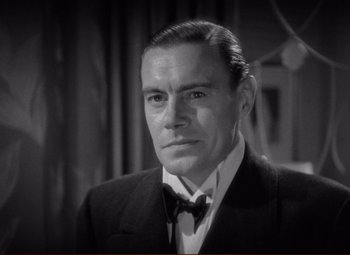 Movie still from “History Is Made at Night” (1937), directed by Frank Borzage – A man wearing a suit and a bow tie; Close Up shot, High angle