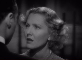 Movie still from “History Is Made at Night” (1937), directed by Frank Borzage – An old photo of a woman in a dress; Close Up shot, Over the shoulder angle