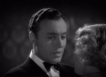Movie still from “History Is Made at Night” (1937), directed by Frank Borzage – A man in a suit and tie with a woman in a black dress; Close Up shot, High angle