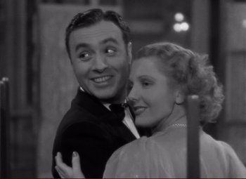 Movie still from “History Is Made at Night” (1937), directed by Frank Borzage – A man and a woman posing for a picture; Close Up shot, High angle