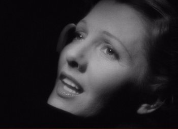 Movie still from “History Is Made at Night” (1937), directed by Frank Borzage – A black - and - white photo of a woman's face; Close Up shot, Low angle