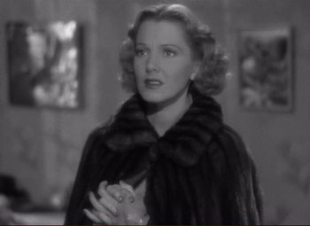 Movie still from “History Is Made at Night” (1937), directed by Frank Borzage – An old photo of a woman wearing a fur coat; Close Up shot, Over the shoulder angle