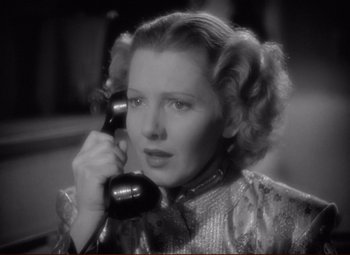 Movie still from “History Is Made at Night” (1937), directed by Frank Borzage – A woman holding a phone up to her ear; Close Up shot, High angle