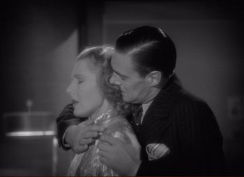 Movie still from “History Is Made at Night” (1937), directed by Frank Borzage – A man and a woman embracing each other in black and white; Close Up shot, High angle