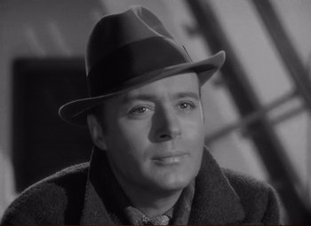 Movie still from “History Is Made at Night” (1937), directed by Frank Borzage – A man wearing a hat and a coat; Close Up shot, Low angle