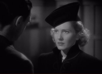 Movie still from “History Is Made at Night” (1937), directed by Frank Borzage – A black and white photo of a woman wearing a hat; Close Up shot, Over the shoulder angle